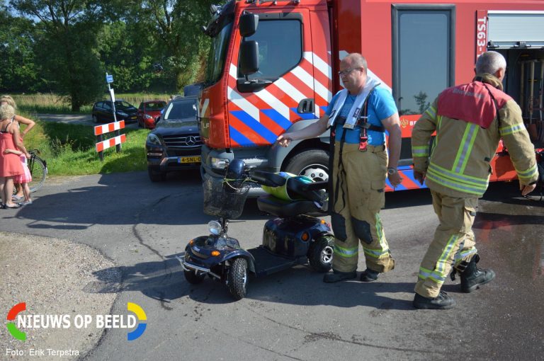 Vrouw met scootmobiel te water Langesingel Brielle