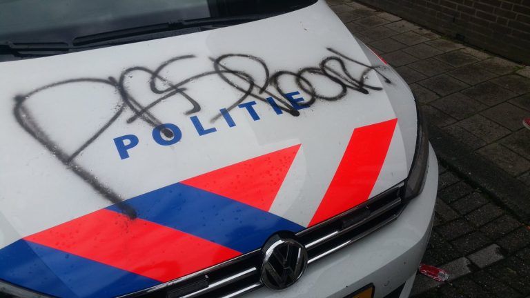 Politieauto onder de graffiti gespoten Ambachtsplein Rotterdam (update)